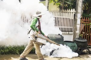Man is using thermal fog machine to protect mosquito spreading Man is using thermal fog machine to protect mosquito spreading