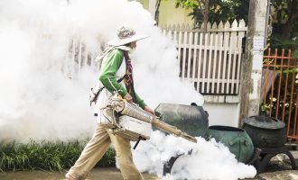 Man is using thermal fog machine to protect mosquito spreading Man is using thermal fog machine to protect mosquito spreading